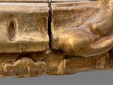 a close up of a gold statue of a person