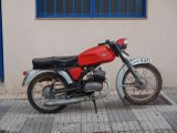 a red motorcycle parked on the side of the street