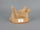 a brown cat statue with a tag on it ' s neck