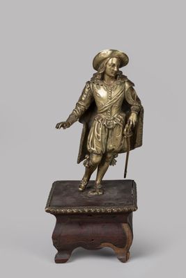 bronze figure of a man with a cane and hat on a stand