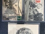 three old postcards of a train and a clock on a table