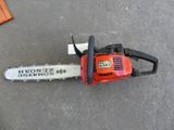 a chainsaw sitting on the ground next to a box