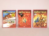 three comic books are lined up on a white surface