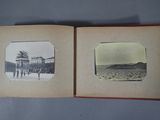 an old photo of a couple of people standing in front of an open book