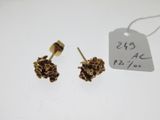 a close up of a pair of earrings with a price tag