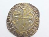 a close up of a coin with a cross on it