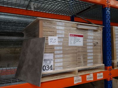 a large stack of boxes sitting on a shelf in a warehouse