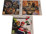 three nintendo wii games are sitting on a white surface