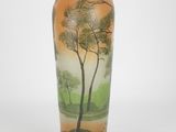 a vase with a painting of trees on it