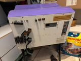 a machine that is sitting on the floor next to a box of cereal