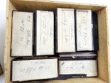 a wooden box filled with old books and a pair of scissors