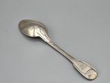 silver spoon on a gray surface with a white background