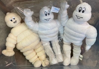 trois momies en peluche dans un bac en plastique avec une étiquette de prix