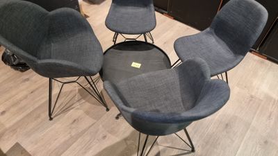 three chairs and a table in a room with wood flooring