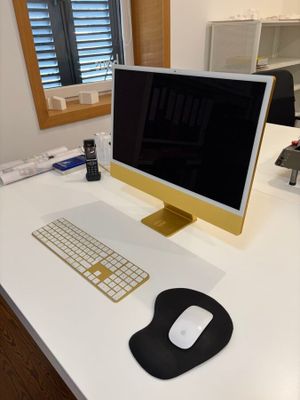 a computer on a desk with a keyboard and mouse