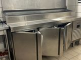 a large stainless steel kitchen with a sink and dishwasher
