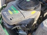 a lawn mower that is sitting on the ground