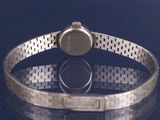 a watch that is sitting on a bracelet on a table