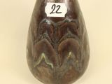 a small vase with a number on it sitting on a table