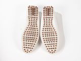 the soles of a pair of white shoes with brown dots on them