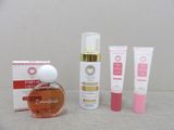 a bottle of perfume next to a box of creams and a tube of lotion