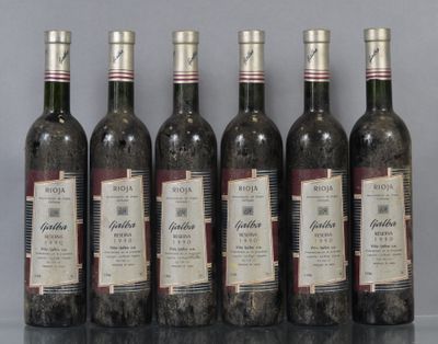 six bottles of wine sitting on top of a table next to each other