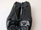 two pairs of black shoes sitting on top of a white table