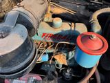 a close up of a car engine with a red cap on it