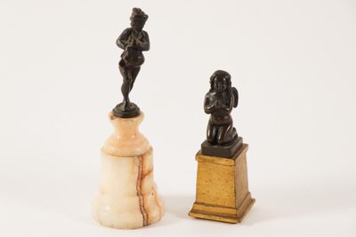 pair of antique figurines of a man and a woman on marble bases