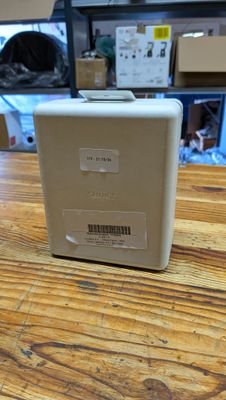 a white box sitting on top of a wooden table
