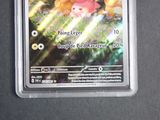 a pokemon card in a plastic holder on a table