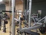a gym with a lot of machines in the room