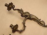 a pair of antique brass candlesticks on a table