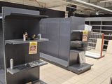 many empty shelves in a store that are empty