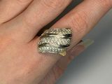 a woman ' s hand with a ring on it