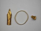 a close up of a gold object with a ring on a table