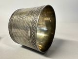 a close up of a silver cuff with a design on it