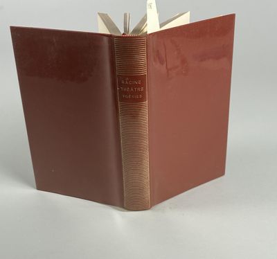 a book with a red cover sitting on top of a white table