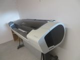 a large printer sitting on a stand in a room