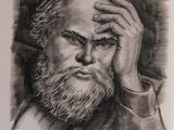 portrait of a man with a beard holding his head in his hands