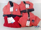 four pairs of red and blue sweaters with tags on them
