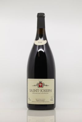 bottle of red wine with a white label on a white surface