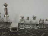 bottles and salt shakers are lined up on a counter top