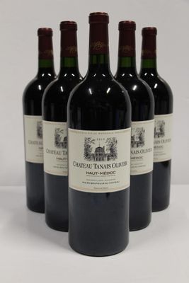 four bottles of red wine are lined up on a white surface