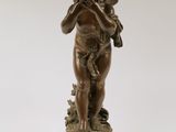 an image of a bronze statue of a boy holding a bird