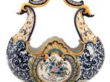 a decorative vase with a peacock design on it