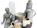 many vases that are sitting on a white surface