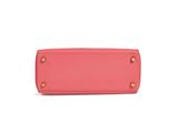 a pink purse on a white background with a white background