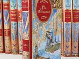 a red book with a picture of a ship on it