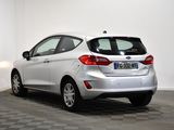 the rear end of a white car is parked in a room